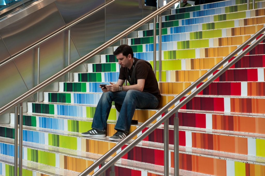 Man sitting alone on some bleachers