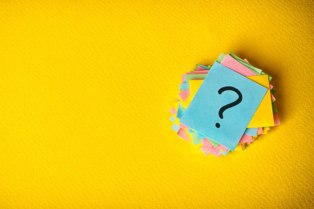 question mark on sticky note against yellow background